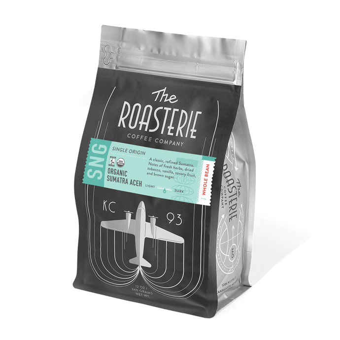 Sumatra Aceh Fair Trade Organic coffee bag with fresh herbs and brown sugar tasting notes displayed on packaging